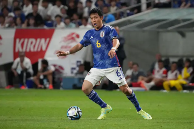 Wattaru Endo dribbles the ball for Japan.