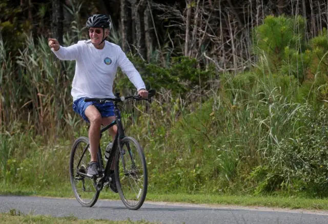 Joe Biden riding a bike.