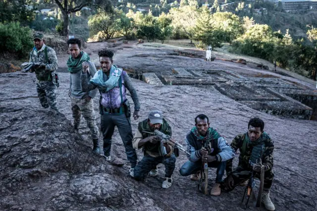 Amhara Fano militia fighters pose at Saint George Church in Lalibela, on December 7, 2021.