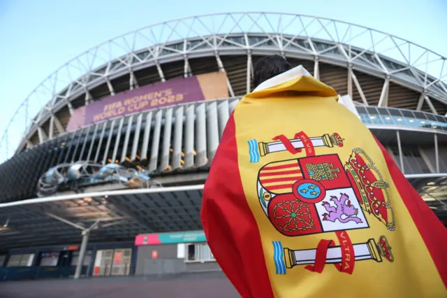 A Spanish fan adorned with the country's flag arrives at the stadium.