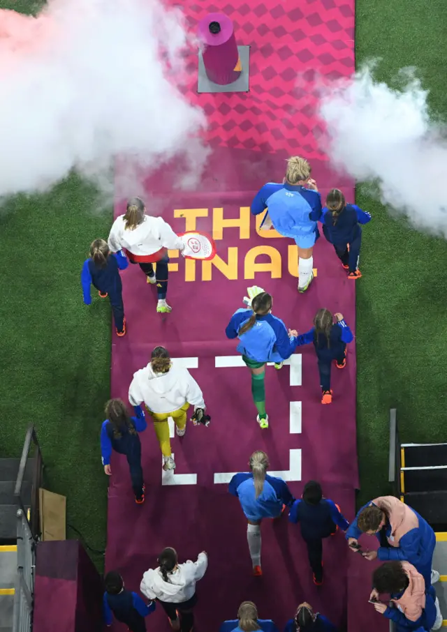 The teams walk out of the tunnel for the national anthems.