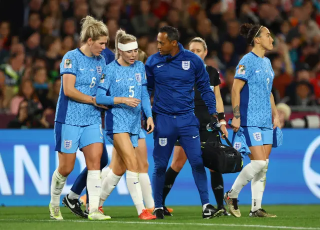 Greenwood is escorted off the pitch heavily bandaged on her head.