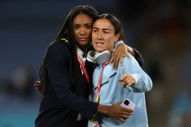 Club teammates Paralluelo and Bronze embrace one another on the pitch.