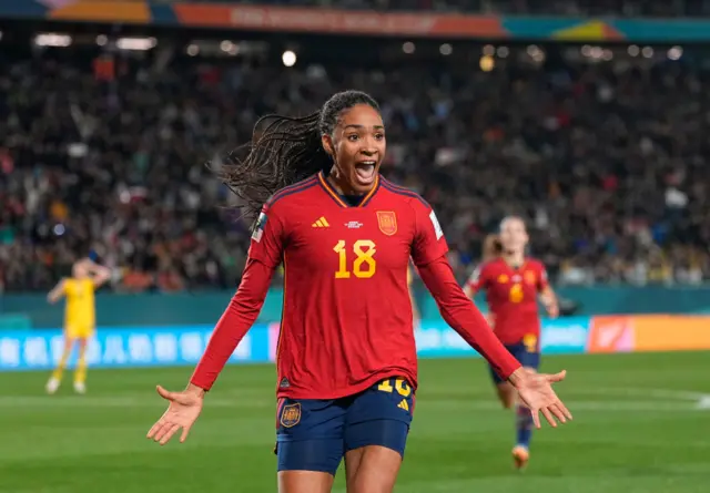 Paralluelo celebrates her goal v Sweden stretching her arms out wide.