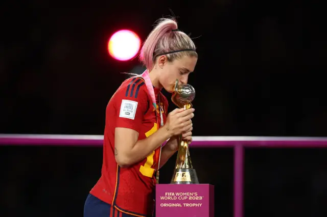 Putellas walks past the trophy and leaves it a kiss on her way.