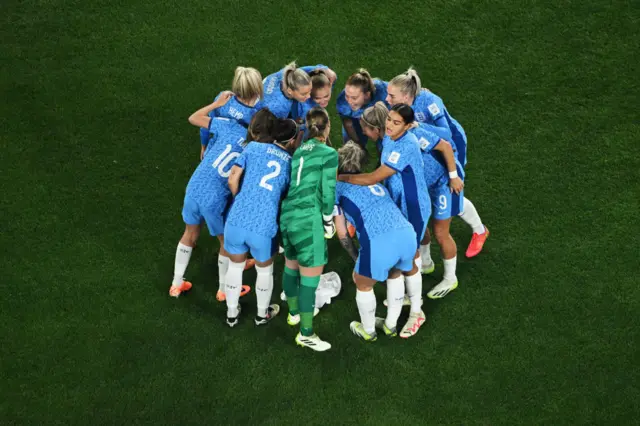 The England players huddle on the pitch before kick off.