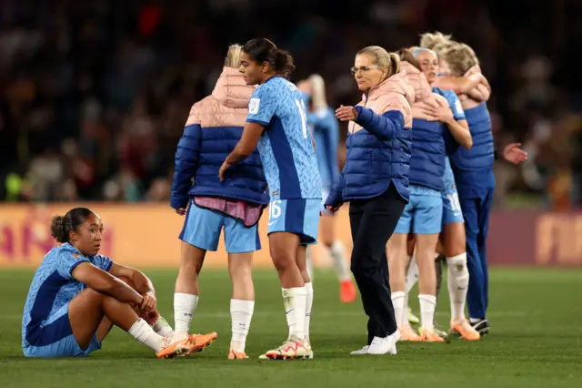 Wiegman consoles the devastated England players.