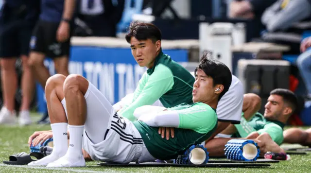 Celtic's Kwon Hyeok-kyu (front) and Yang Hyun-Jun (back) warm up at Rugby Park