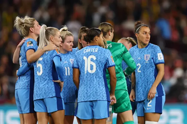 England players huddle before kick off in the second half.