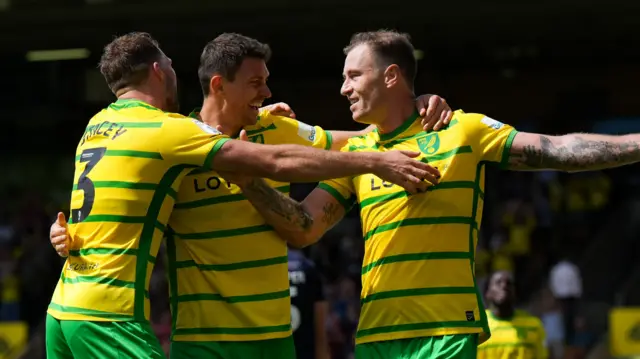 Ashley Barnes (right) celebrates his goal for Norwich with two of his team-mates