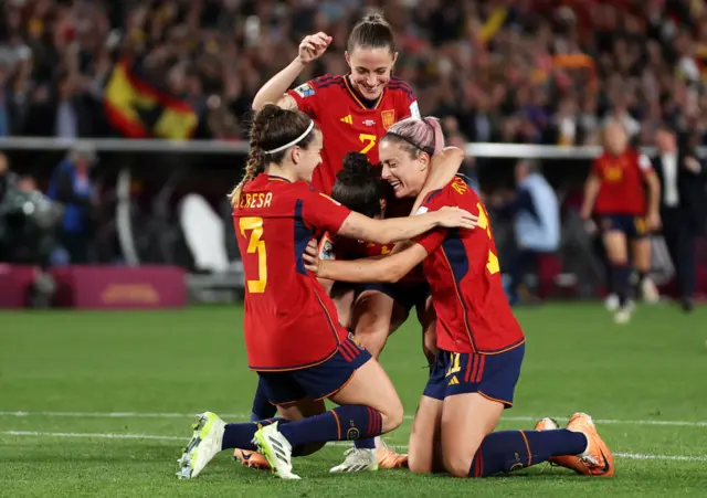 Spain players celebrate together at full time.