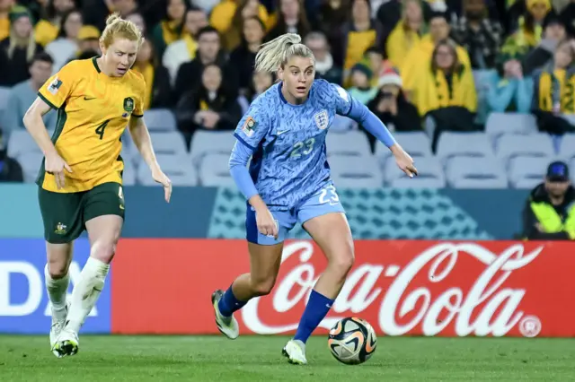 Clare Polkinghorne of Australia and Alessia Russo of England battle for the ball