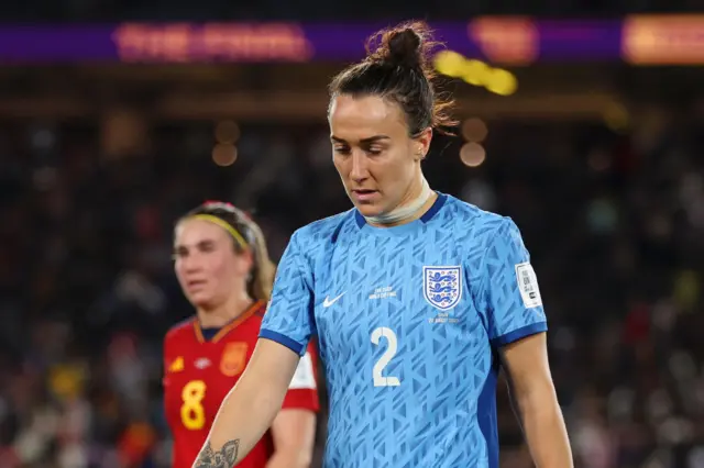 Lucy Bronze heads down the tunnel with her gaze on the floor.