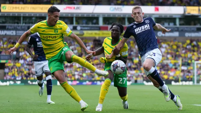 Millwall and Norwich players challenge for the ball during their Championship match