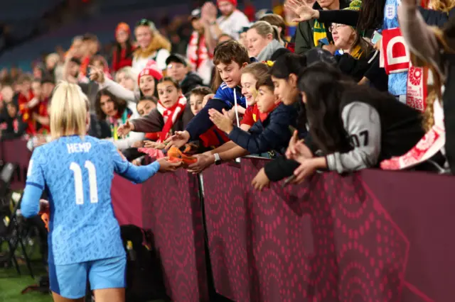 Lauren Hmep shakes the hands of young fans after the game.