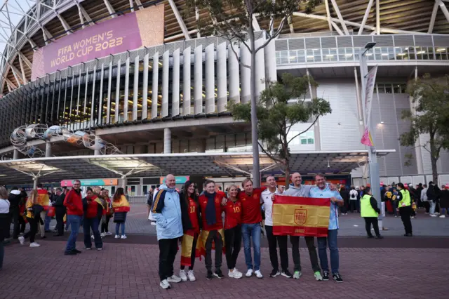 Spanish fans pose with the country's flag outside of Stadium Australia.