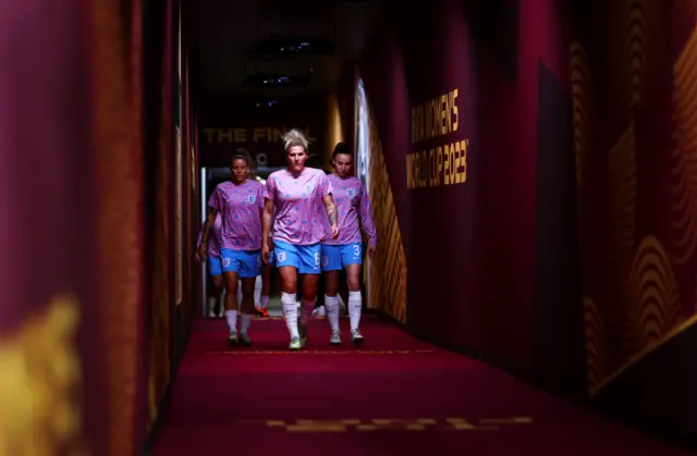 Millie Bright leads England down the tunnel.