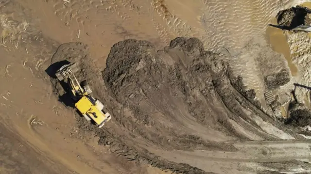 Aerial image shows earth-moving machinery surounded by mud in Rancho Mirage, California