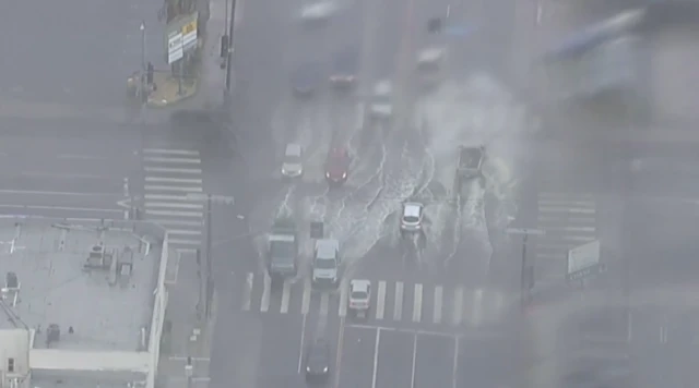 Cars drive down flooded roads in Pacoima, a Los Angeles neighbourhood