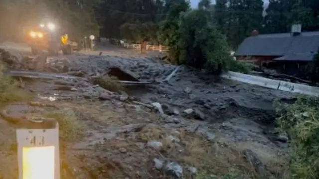 A view of gushing flood water and a damaged road during Tropical Storm Hilary in Oak Glen, California, U.S. August 20, 2023 in this screengrab obtained from a social media video