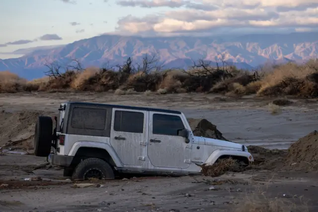 A Jeep remains stuck in mud off a road that was hit by a flash flood in the aftermath of Tropical Storm Hilary on August 21, 2023 near Indio California.