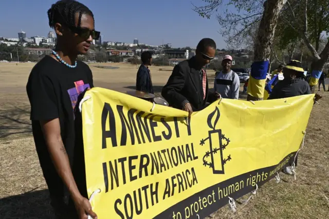 Members of Amnesty International South Africa and partners, the Ukrainian Association of South Africa and the Helen Suzman Foundation protest against Russia's invasion of Ukraine in Johannesburg on August 22, 2023, during the 2023 BRICS Summit.