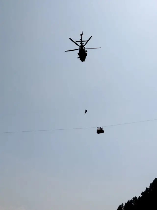 Helicopter arrives at standard cable car