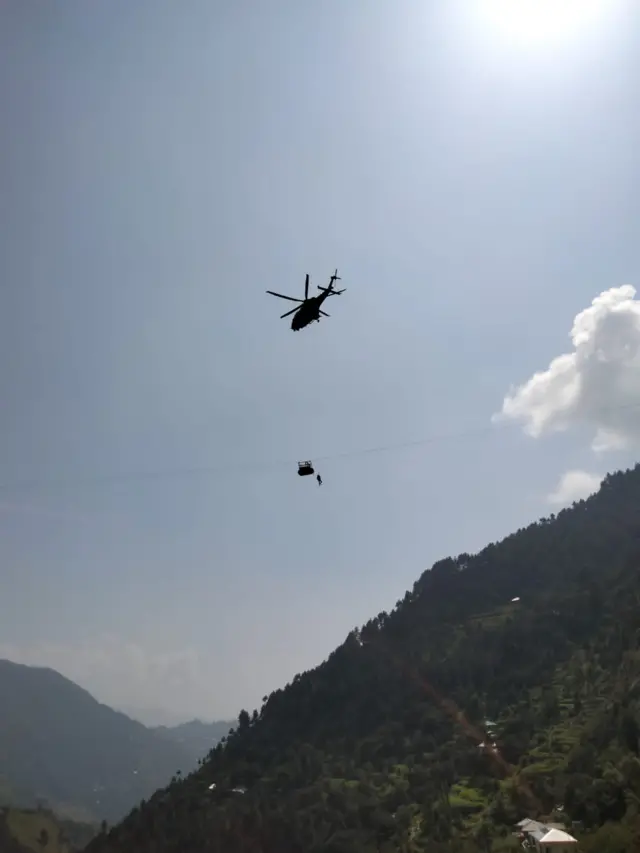 Helicopter arrives at standard cable car