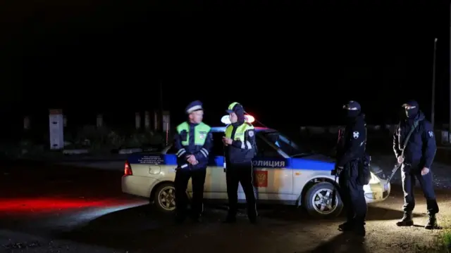 Description Police stand guard at a checkpoint on a road near the accident scene following the crash of a private jet linked to Wagner mercenary chief Yevgeny Prigozhin in the Tver region, Russia, August 24, 2023.