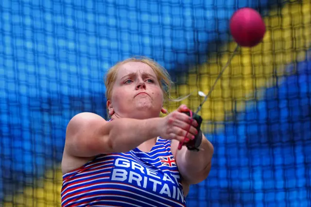 Charlotte Payne swings the hammer inside the hammer throw net.