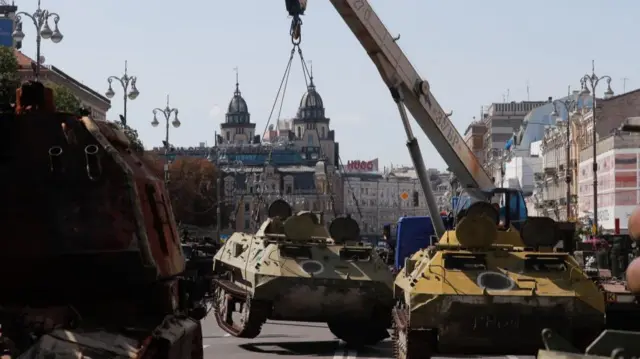 Army and municipal workers set up damaged Russian armored military vehicles that were seized by the Ukrainian army amid the Russian invasion, along Khreshchatyk Street in Kyiv, Ukraine, 22 August 2023