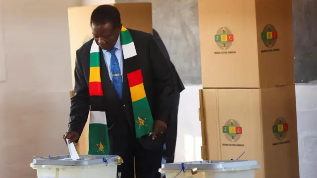 Zimbabwean president and leader of the ruling ZANU-PF, Emmerson Mnangagwa, gestures as he casts his vote in the general elections