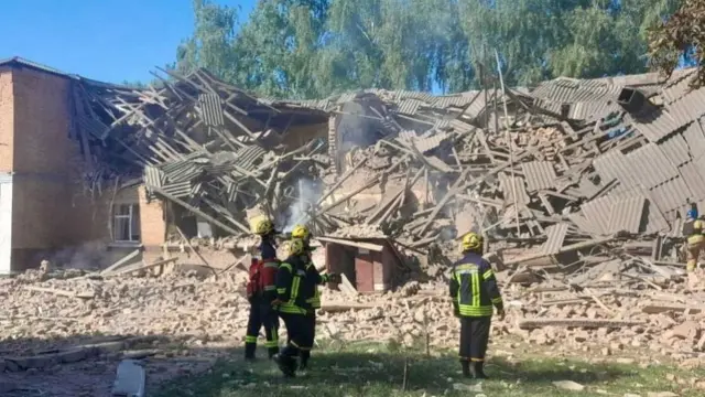 A rescue team gathered around the rubble