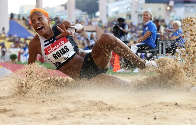 Yulimar Rojas lands in the sand during the triple jump event at the Monaco Diamond League