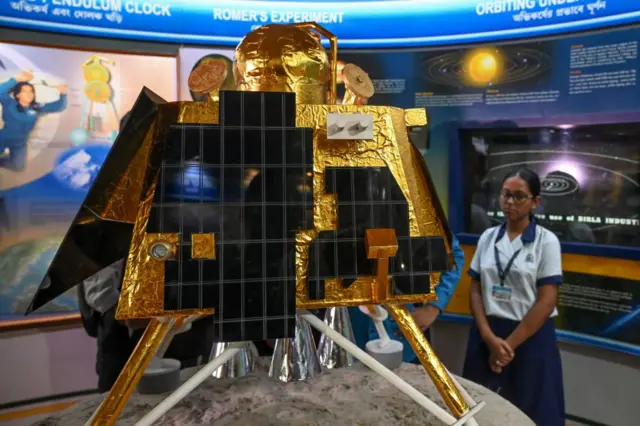 School students look at a model of Chandrayaan-3's Lander Module (LM) named as Vikram, at a technical museum in Kolkata on August 23, 2023.