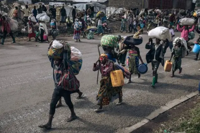 War-displaced people flee towards the city of Goma, eastern Republic of Congo, on November 15, 2022. Thousands of displaced people began to flee after soldiers retreated to Kanyarushinya, an informal camp of over 40,000 people in the northern district of Goma