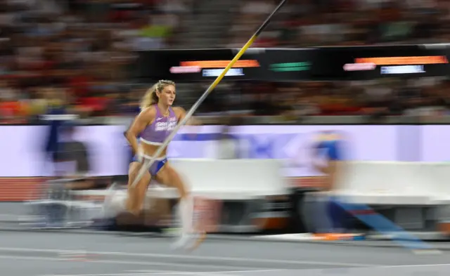 Molly Caudery runs with the pole vault in hand in a stylistic, blurry picture