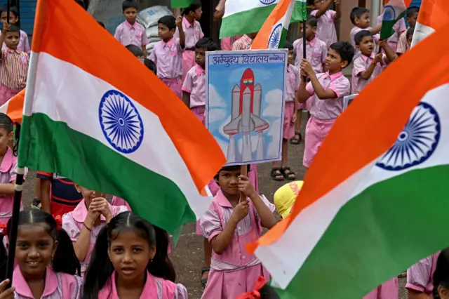 tudents wave India's national flag as they hold posters in support of the Chandrayaan-3 spacecraft in Mumbai on August 22, 2023