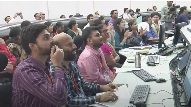 Tense faces in the command room