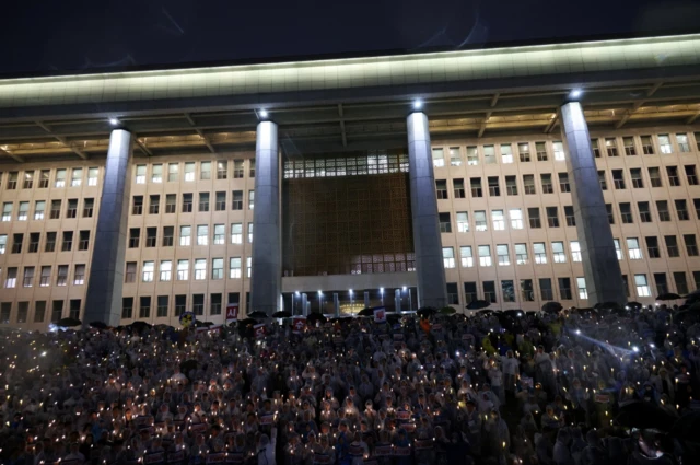 A candlelight protest against Japan's release outside Seoul's parliament on 23 August