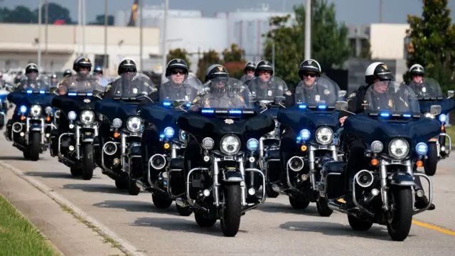 Law enforcement officers drive near Atlanta Hartsfield-Jackson International Airport as former U.S. President Donald Trump is expected to turn himself in to be processed at Fulton County Jail after his Georgia indictment.