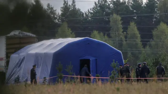 Police officers keep guard near the site of the crash of a private jet linked to Prigozhin