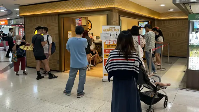 People queuing outside of a Japanese sushi chain in Hong Kong to be seated, 23 Aug 2023