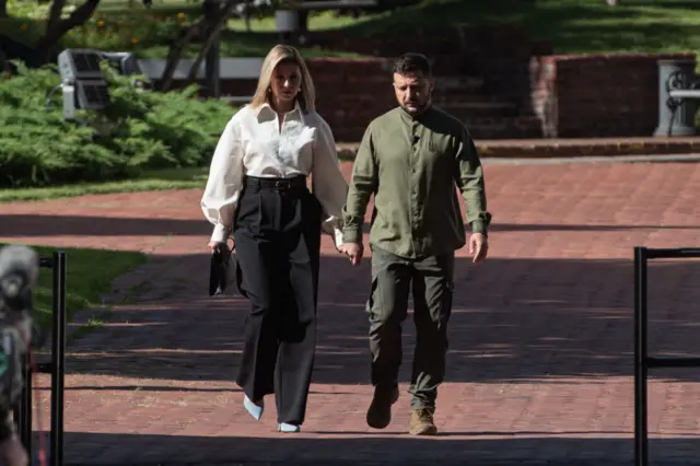 Olena Zelenska and Volodymyr Zelensky walk hand-in-hand