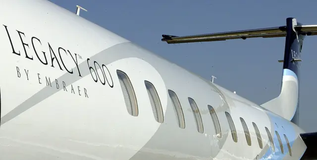 An Embraer Legacy 600 jet stands on the runway at the Farnborough Air Show.