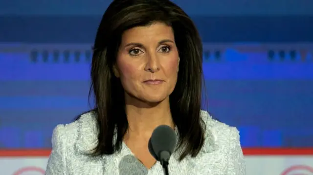 Former South Carolina Governor Nikki Haley stands on stage before the start of the Republican presidential debate,