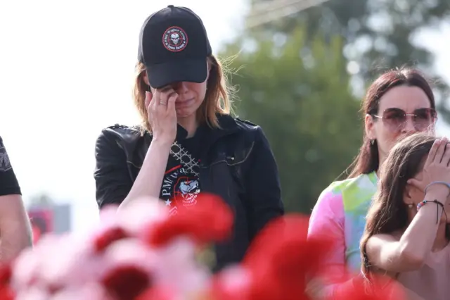 A woman becomes emotional as she stands in front of the memorial in St Petersburg