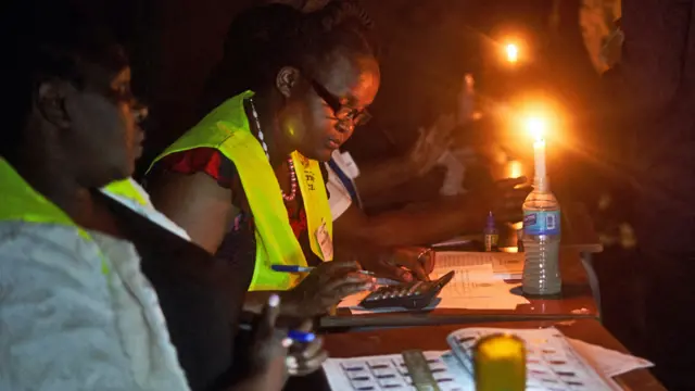 Election officials work with candle light at a polling station for Zimbabwe's presidential and legislative elections in Bulawayo - 23 August  2023