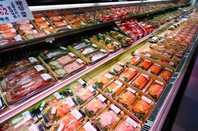 Sushi and sashimi are seen at a supermarket