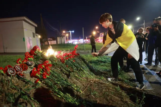 People lay flowers and light candles for Prigozhin in Saint Petersburg